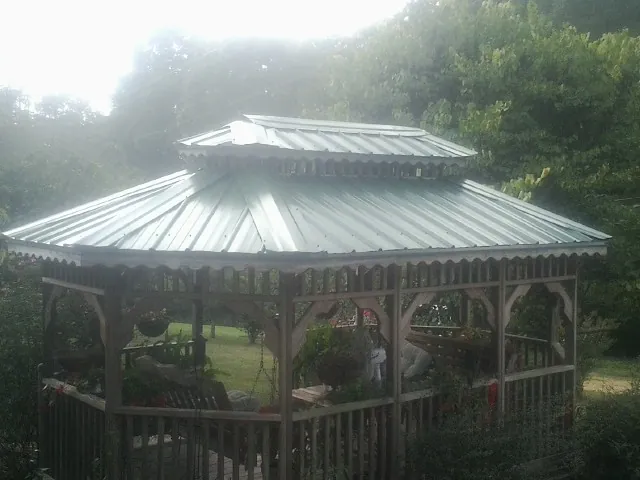 Two tier green metal roof on a garden gazebo in Melissa